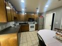 Galley kitchen with wood cabinets, white appliances, and a dining area at 3456 Macklen Rd. # 18-B, Myrtle Beach, SC 29588