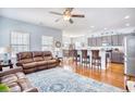 Open living room featuring hardwood floors, leather sofas, and a ceiling fan at 911 Ocean Pines Ct., North Myrtle Beach, SC 29582