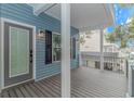 Gray composite deck with glass door entrance to the house at 6001-1122A S Kings Hwy., Myrtle Beach, SC 29575