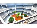 Ground level courtyard with tropical landscaping, surrounded by balconies at 10166 Beach Dr. # 5306, Calabash, NC 28467