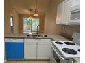 White kitchen cabinets, granite counters, and stainless steel appliances at 3681 Claypond Rd. # 3107, Myrtle Beach, SC 29579
