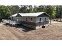 Aerial view of a gray and beige house with a large deck at 7122 Cox Lake Dr., Mullins, SC 29574