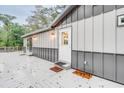 White door and gray siding on the exterior of the house with a deck at 7122 Cox Lake Dr., Mullins, SC 29574