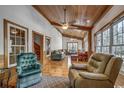 Relaxing sunroom with hardwood floors and ample natural light at 7018 Cox Lake Ct., Mullins, SC 29574