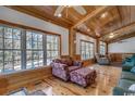 Spacious living area with hardwood floors, large windows, and comfortable seating at 7018 Cox Lake Ct., Mullins, SC 29574