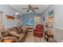 Cozy living room featuring a brown sofa, recliner, and a TV at 6001-1359 S Kings Hwy., Myrtle Beach, SC 29575