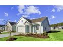 Two-story light blue house with white accents and a two-car garage. Landscaped lawn and trees at 3022 Deerberry Place, Longs, SC 29568