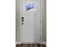 White front door with a glass panel and keyless entry at 3022 Deerberry Place, Longs, SC 29568