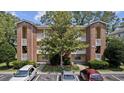 Two-story brick building with balconies and parking at 4251 Villas Dr. # 309, Little River, SC 29566