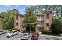Two-story brick building with balconies and parking at 4251 Villas Dr. # 309, Little River, SC 29566