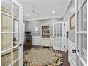 Home office with built-in shelving, hardwood floors, and French doors at 6438 Cascata Dr., Myrtle Beach, SC 29572