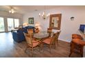 Bright dining area with glass table, wicker chairs, and a chandelier at 601 N Hillside Dr. # 2123, North Myrtle Beach, SC 29582