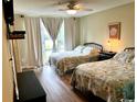 Two twin beds in a bright bedroom with plenty of natural light at 200 Landing Rd. # 111, North Myrtle Beach, SC 29582