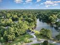 Aerial view of a house on a waterfront lot with lush green trees and a tranquil lake nearby at 1886 Southwood Dr., Myrtle Beach, SC 29575
