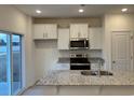 Modern kitchen with white cabinets, granite counters and stainless steel appliances at 428 Hallie Martin Rd., Conway, SC 29527