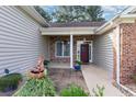 Inviting front entry with stone accents, a red door, and a charming water feature at 4839 Seabreeze Ln., Myrtle Beach, SC 29579