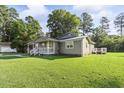 Gray house with white trim and a large grassy yard at 1210 John St., Mullins, SC 29574