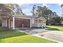Gray house with carport and a well-maintained lawn at 1210 John St., Mullins, SC 29574