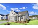 Two-story house with gray siding and a front porch at 3030 Deerberry Place, Longs, SC 29568