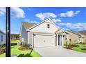 Newly built home with gray siding and a two car garage at 3030 Deerberry Place, Longs, SC 29568