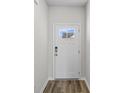 White front door with a glass panel and keyless entry at 3030 Deerberry Place, Longs, SC 29568