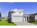 New construction home with light blue siding, two-car garage, and landscaped lawn at 3042 Deerberry Place, Longs, SC 29568