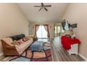 Spacious living room with vaulted ceilings, hardwood floors, and access to a patio at 333 Carolina Springs Ct., Conway, SC 29527