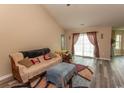Spacious living room with vaulted ceilings, hardwood floors, and access to a patio at 333 Carolina Springs Ct., Conway, SC 29527