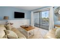Relaxing living room with balcony access and coastal decor at 5905 S Kings Highway # 210B, Myrtle Beach, SC 29575