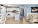 Well-equipped kitchen with white cabinetry and tiled backsplash at 5905 S Kings Highway # 210B, Myrtle Beach, SC 29575