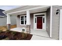 Front porch with stone columns and red front door at 1205 Nw Calabash Station Blvd., Calabash, NC 28467