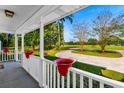 Front porch view of landscaped yard and curved driveway at 736 Millers Rd., Mullins, SC 29574