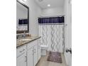 Clean bathroom with granite countertop, white cabinets, and a shower/tub combo at 3722 White Wing Circle, Myrtle Beach, SC 29579