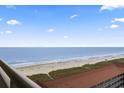 Stunning ocean view from condo balcony showcasing sandy beach and clear sky at 603 S Ocean Blvd. # 1016, North Myrtle Beach, SC 29582