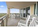 Spacious balcony with outdoor seating, offering relaxing ocean views at 603 S Ocean Blvd. # 1016, North Myrtle Beach, SC 29582