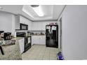 Well-equipped kitchen with granite countertops and white cabinets at 9994 Beach Club Dr. # 901, Myrtle Beach, SC 29572