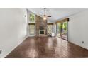 Spacious living area with tile floors, fireplace, and sliding glass doors at 19 South Gate Rd., Myrtle Beach, SC 29572