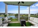 Screened porch with a fire pit and comfortable seating overlooking a lake at 973 Crystal Waterway Dr., Myrtle Beach, SC 29579