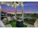 Screened porch with a fire pit and comfortable seating overlooking a lake at 973 Crystal Waterway Dr., Myrtle Beach, SC 29579