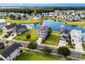 Aerial view of a house near a lake in a residential neighborhood at 973 Crystal Waterway Dr., Myrtle Beach, SC 29579