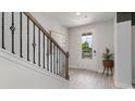 Bright entryway with a staircase featuring an iron railing and hardwood floors at 1889 Brook Park Pl., Conway, SC 29526