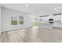 Open concept kitchen with white cabinets, island, and stainless steel appliances at 3539 Rayner Cove Ct., Little River, SC 29566
