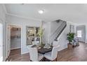 Bright dining area with a round table and four chairs, adjacent to stairs and pantry at 816 Agostino Dr., Myrtle Beach, SC 29579