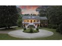Two-story home exterior at dusk, featuring a circular driveway at 4400 Saint Andrews Ct., Murrells Inlet, SC 29576
