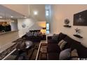 Spacious living room with high ceilings, two sofas, and a coffee table at 1188 Fairway Ln. # 7, Conway, SC 29526