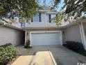 Two story light beige townhome with a two-car garage at 1188 Fairway Ln. # 7, Conway, SC 29526