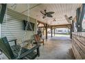 Relaxing patio with swing, ceiling fan, and partial view of the street at 6001 - 1870 S Kings Hwy., Myrtle Beach, SC 29575