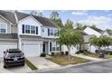 Attractive row of townhouses with gray siding and landscaping at 160 Freeboard Ln. # 802, Carolina Shores, NC 28467