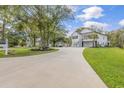 House exterior with a long driveway and landscaping at 5848 Creekside Dr., Myrtle Beach, SC 29588