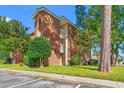 Brick building with landscaping and parking at 4273 Villas Dr. # 1007, Little River, SC 29566